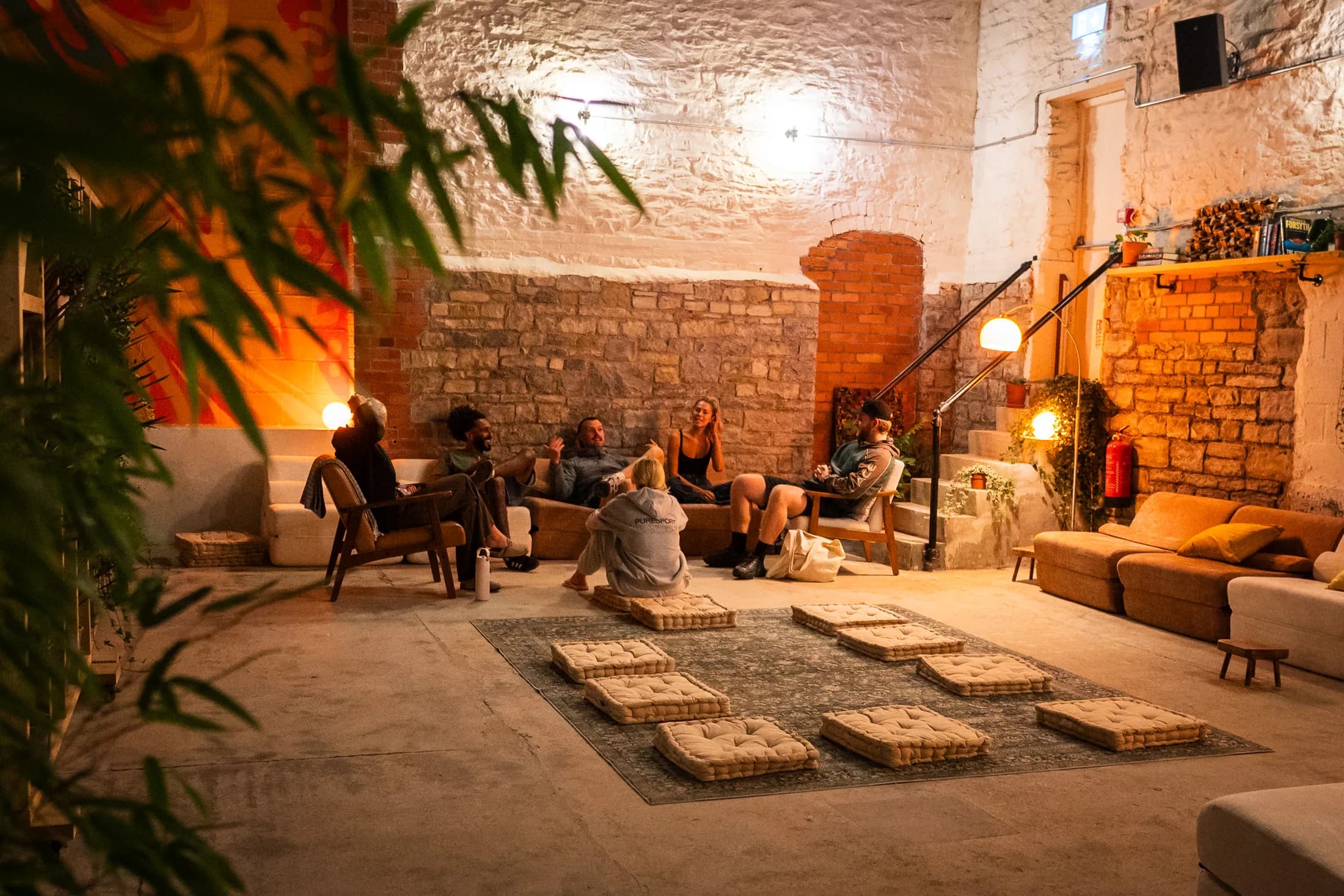 Guests relaxing together in the warmly lit HOTBOX lounge