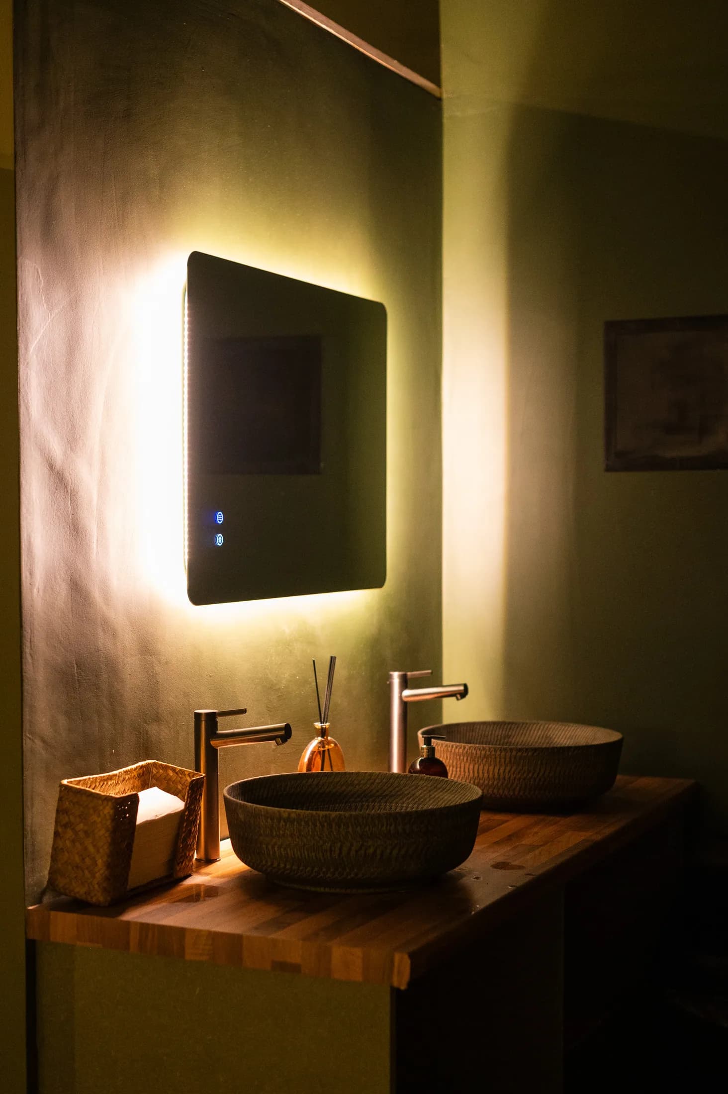 Warmly lit mirror and sink in the HOTBOX changing room