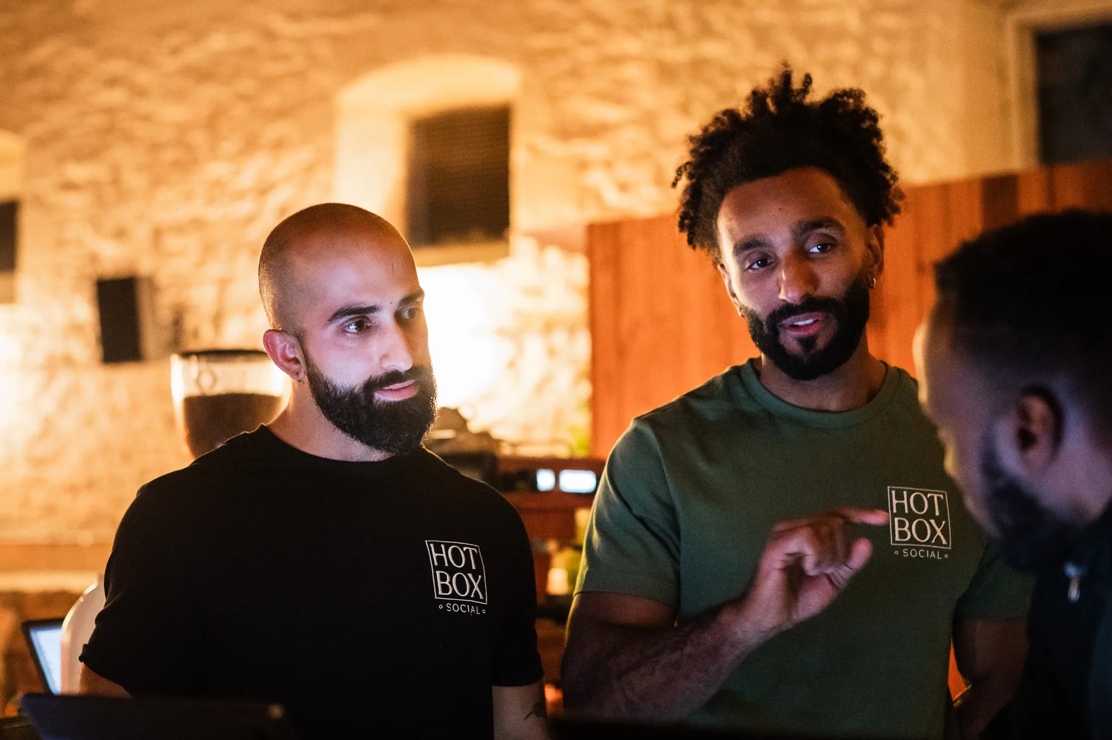HOTBOX team members talking in the venue