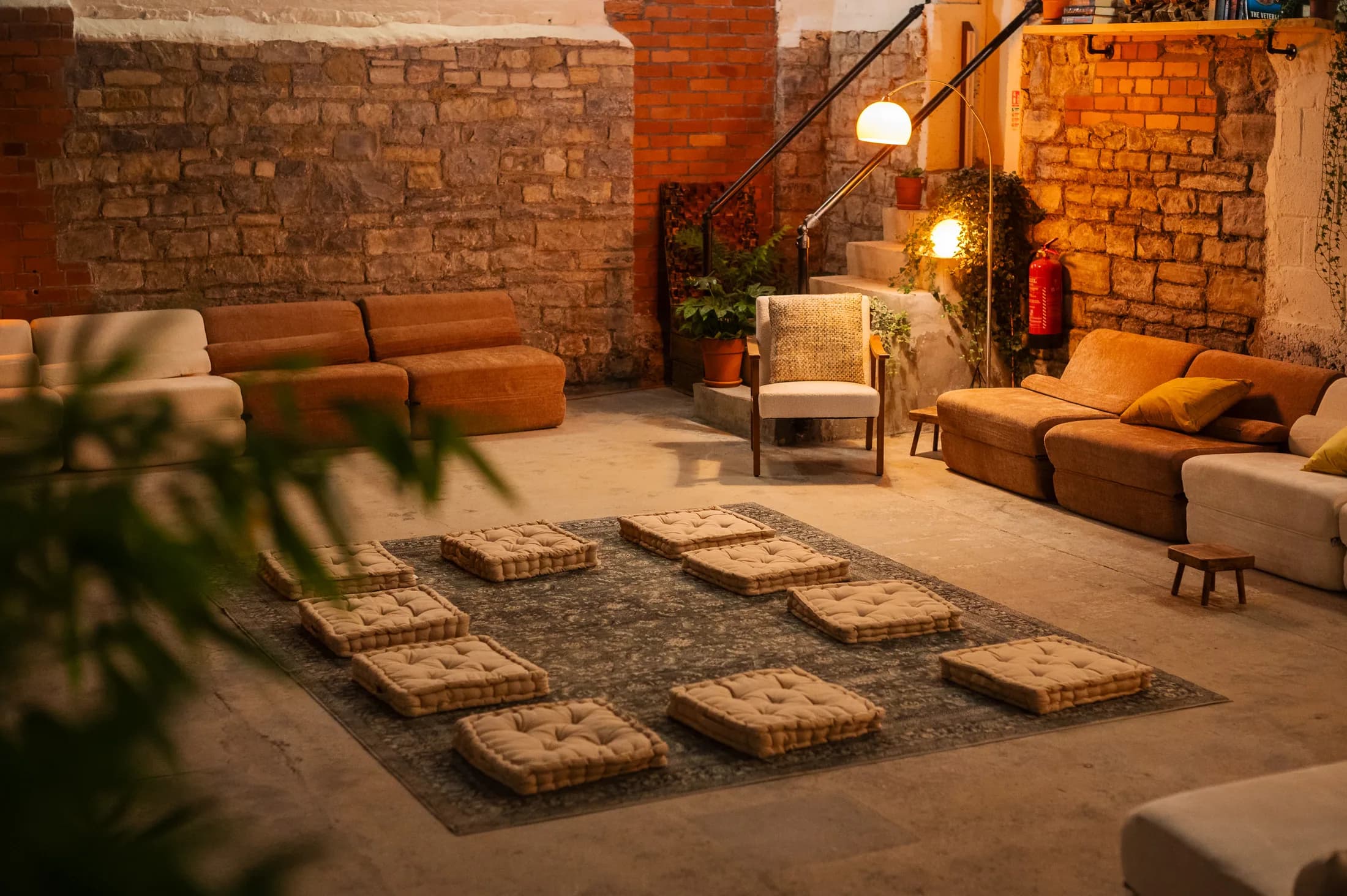 Warm lounge lighting, sofas and floor cushions at HOTBOX