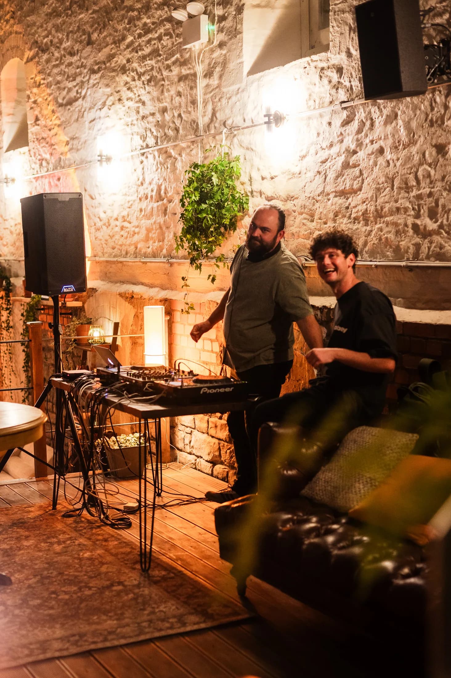 Two DJs playing music in the HOTBOX lounge